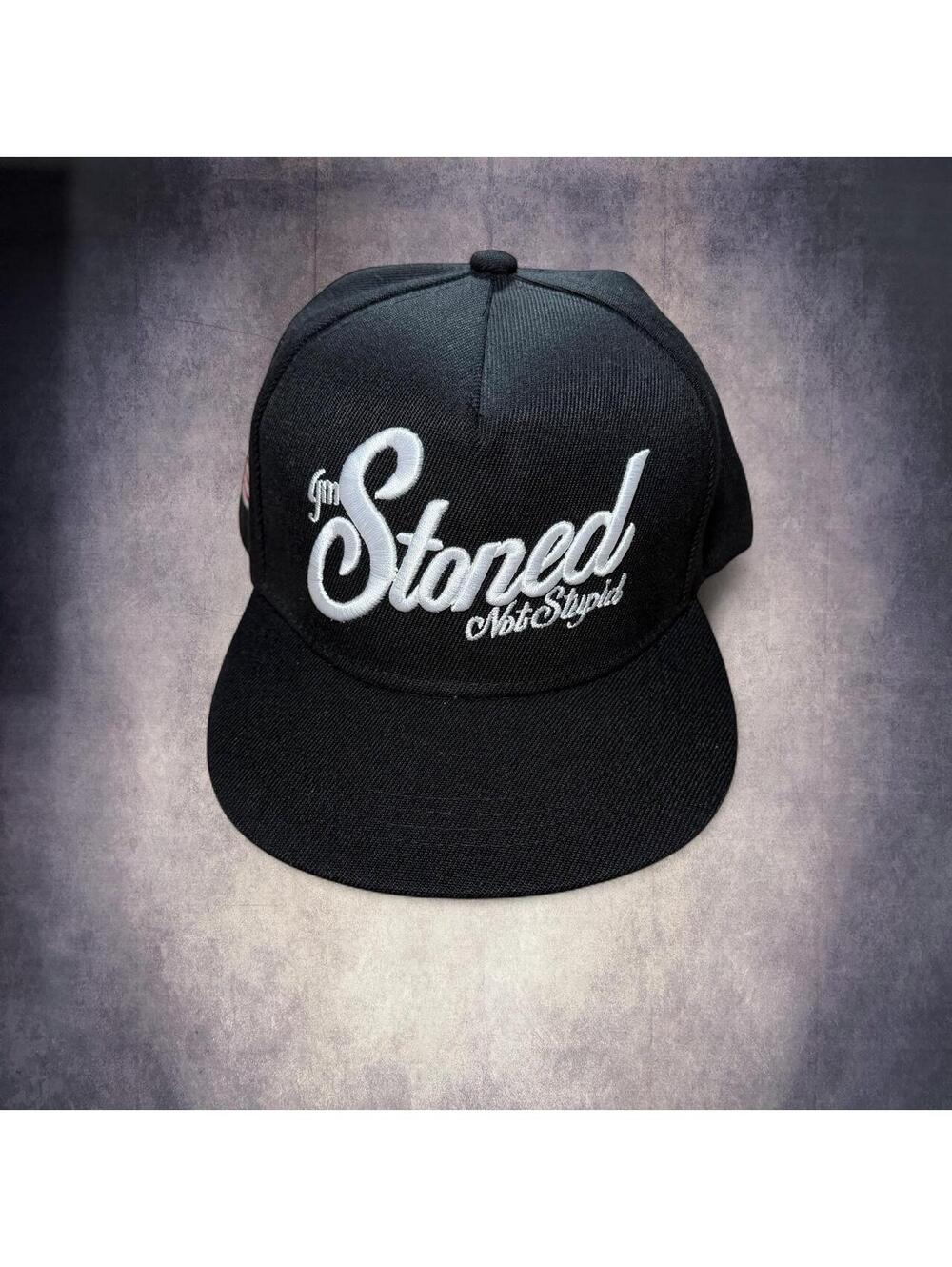 Black "Stoned Not Stupid" snapback hat with white embroidered text